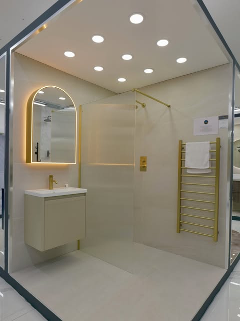 Walk-in shower with brushed gold bathroom fittings