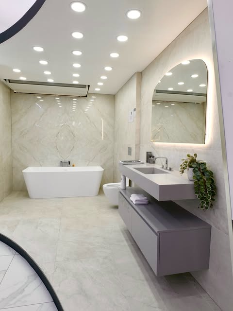 Bright marble-effect bathroom with a freestanding bath